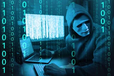 Anonymous man in mask with computers and binary code in darkness 库存照片