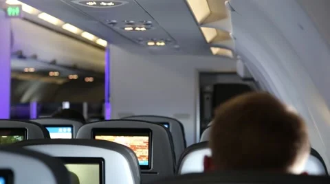 An anonymous man sitting in an airplan cabine, from behind Stock Footage 63270143