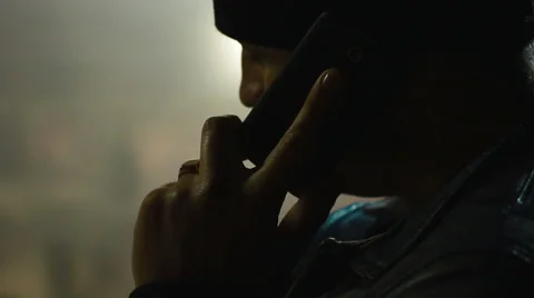 Anonymous man talking on phone in a dark room Stock Footage