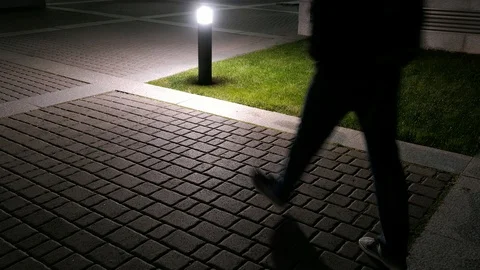 Anonymous Man Walking City Pavement at Night Wearing Jeans and Sneakers Stock Footage 99056566
