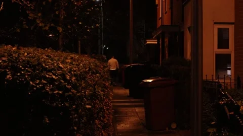 Anonymous man walking down the street in a city in England Stock Footage 258174477