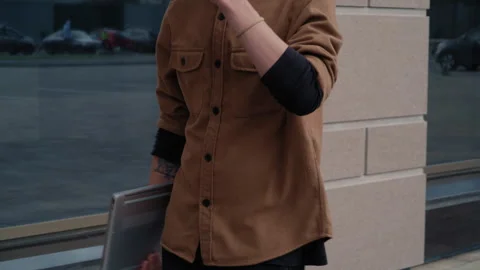 Anonymous Man Walking with Laptop and Coffee Near Modern Building 库存影片 317560873