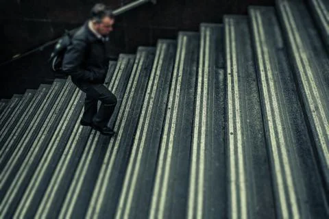 Anonymous man walking up stairs Stock-Fotos