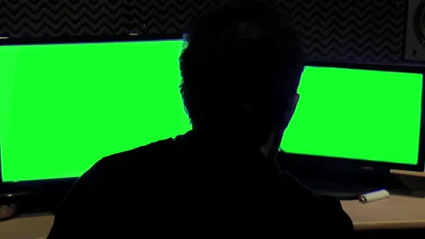 Anonymous Man Working at Studio with Two Monitors Green Screen. Video stock 244931766