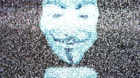 Anonymous mask on TV screen Stock Footage