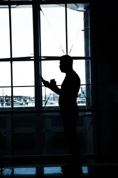 An anonymous men looking to his mobile phone Photos