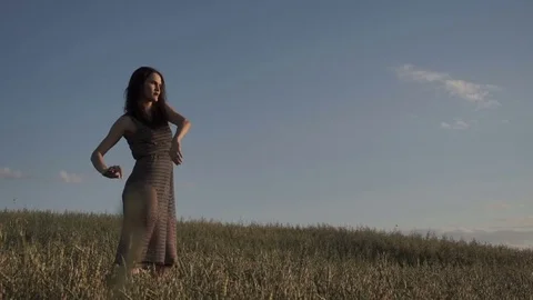 Anonymous model dancing in field Stockbeeldmateriaal 78884921