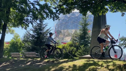 Anonymous Mom and Son biking by Science World Creekside Park Stock Footage 280879434
