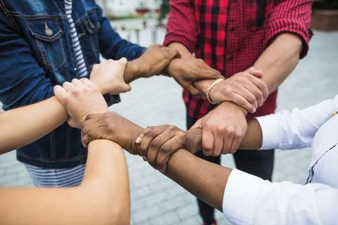 Anonymous multiracial people stacking hands. High quality photo Stock Photos