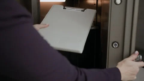 Anonymous Office Worker Putting Documents in Safe Stock Footage 288810153