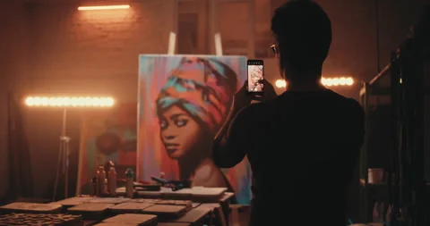 Anonymous painter taking photo of artwork Stock Footage 144793363