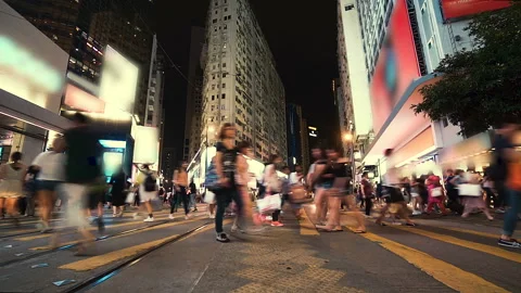 Anonymous pedestrians crossing intersection on busy road in central of big asian Stock Footage 93978613