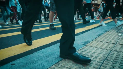 Anonymous pedestrians crossing intersection on busy road  Stock Footage 94647828