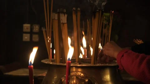 Anonymous People Burning Incense in Temple Offering Prayers 4K Spiritual Video Video stock 295807748