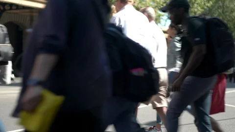 Anonymous people crossing an intersection with tram in background Stock Footage 97121490
