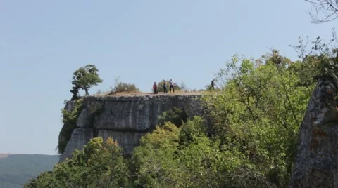 Anonymous People on the Edge of the Cliff Mountain Above the Canyon Stock Footage 54463565