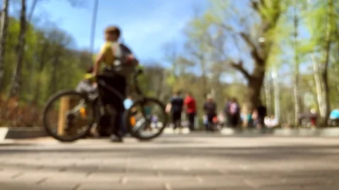 Anonymous people out of focus walking in city park Stock Footage 89443491