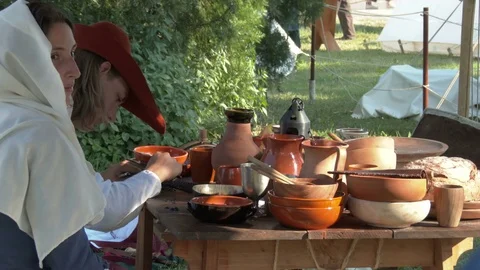 Anonymous people perform an example of everyday life in a medieval camp. Stock-Footage 76290367