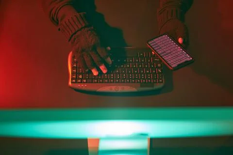 Anonymous people using computer and programming to break code. Cyber securi.. Stock Photos