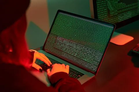 Anonymous people using computer and programming to break code. Cyber securi.. Stock Photos