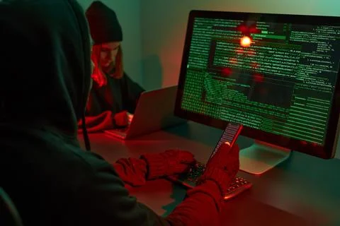Anonymous people using computer and programming to break code. Cyber securi.. Foto stock