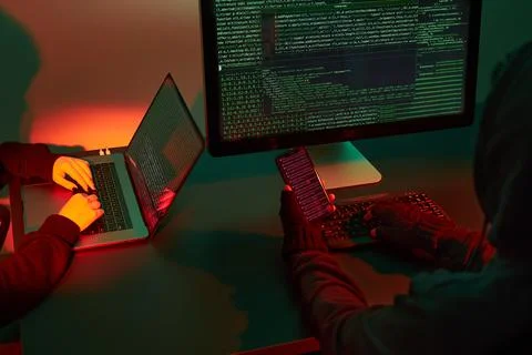 Anonymous people using computer and programming to break code. Cyber securi.. Stock Photos