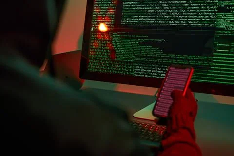Anonymous people using computer and programming to break code. Cyber securi.. Foto stock