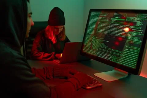 Anonymous people using computer and programming to break code. Cyber securi.. 스톡 사진