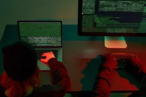 Anonymous people using computer and programming to break code. Cyber securi.. 写真素材