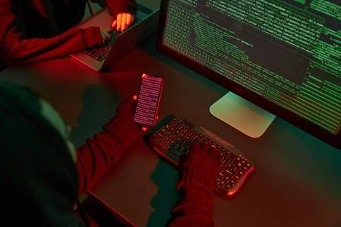 Anonymous people using computer and programming to break code. Cyber secur... 写真素材
