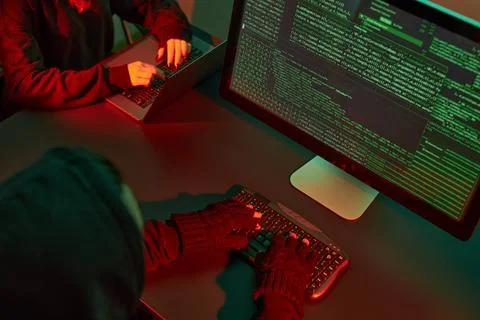 Anonymous people using computer and programming to break code. Cyber secur... 写真素材