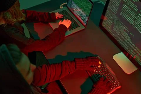 Anonymous people using computer and programming to break code. Cyber secur... 스톡 사진
