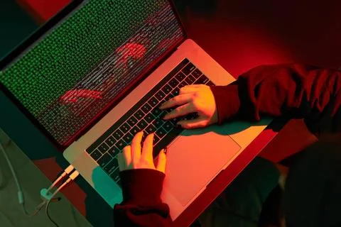 Anonymous people using computer and programming to break code. Cyber secur... 写真素材