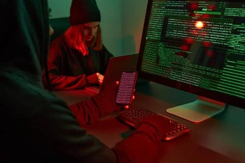 Anonymous people using computer and programming to break code. Cyber secur... 写真素材