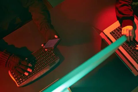 Anonymous people using computer and programming to break code. Cyber secur... Stock-Fotos