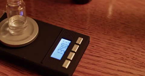 Anonymous perfumer adding aromatic oil into bottle on scales Stock Footage 260983898