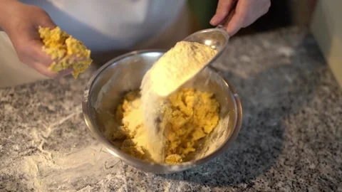 Anonymous person adding flour into dough in kitchen Stock Footage 239512706