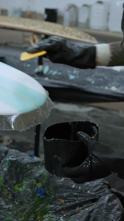 Anonymous person attaching surfboard with scraper Stock Footage 240983112