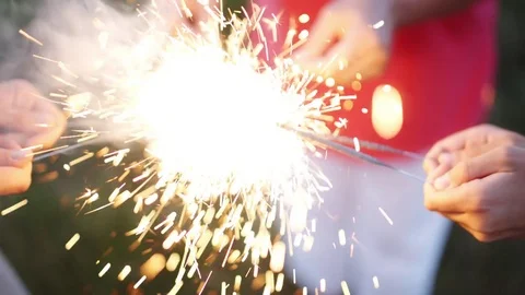 Anonymous person with burning firework Stock Footage 77563447