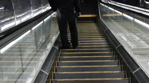 Anonymous person on an escalator Stock Footage 25822033