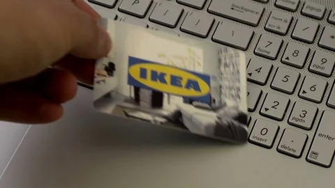 Anonymous Person Puts IKEA Gift Card Onto Laptop Stock Footage 75048510