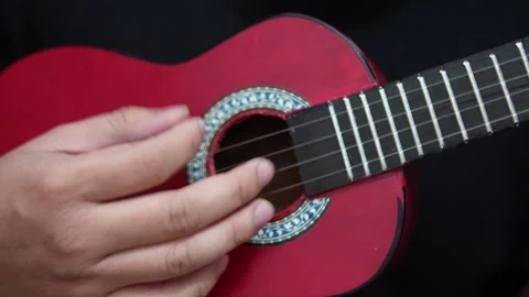 Anonymous person singing while playing ukulele Video stock 293534181