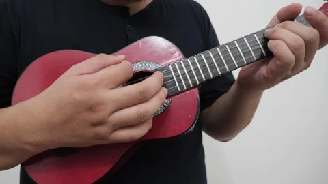 Anonymous person singing while playing ukulele Video stock 293534354