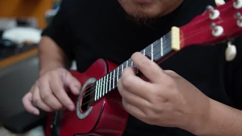 Anonymous person singing while playing ukulele Video stock 293534372