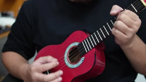 Anonymous person singing while playing ukulele Video stock 293534379