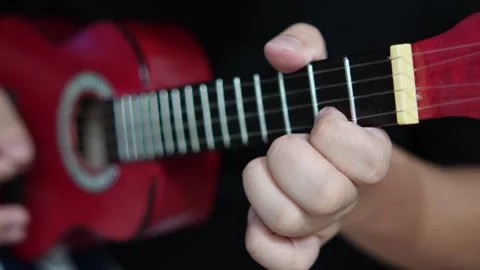 Anonymous person singing while playing ukulele Video stock 293534676