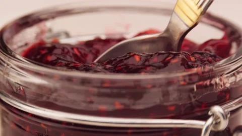 Anonymous person taking raspberry jam Stock Footage 136672691