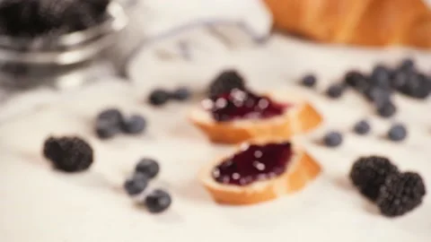 Anonymous person taking toast with jam Stock Footage 136671915
