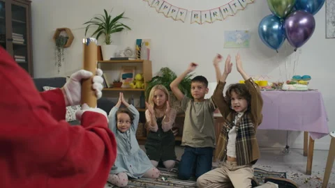 Anonymous Play Assistant Exploding Confetti Tube at Birthday Party 動画素材 263242462