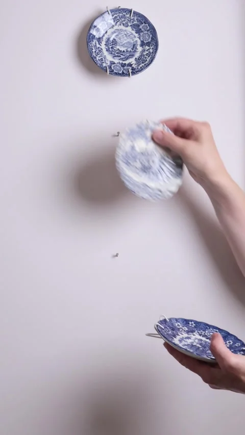 Anonymous remove decorative plates from wall. Items for interior decoration Stock Footage 280238331